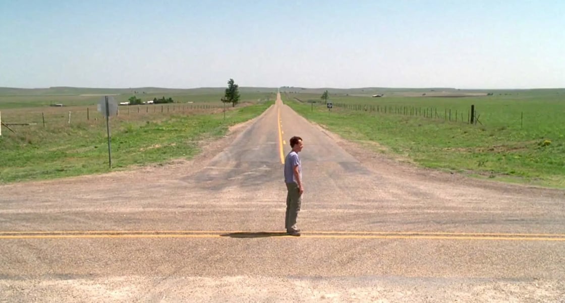 A man standing at a crossroad