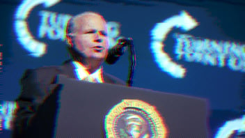 Rush Limbaugh speaking into a microphone at a podium.