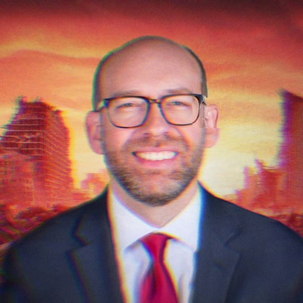 Russell Vought smiling in front of an apocalyptic city background.