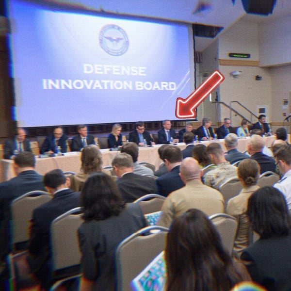 A photo from a defense innovation board meeting with an arrow pointing to Eric Schmidt.