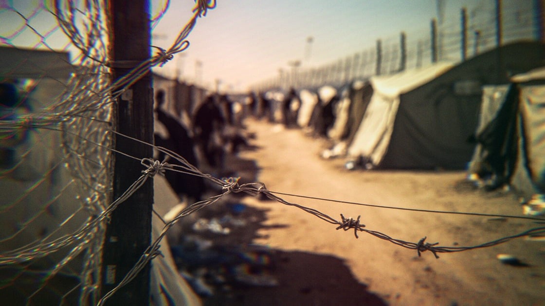 Barbed wire surrounding an encampent at the border