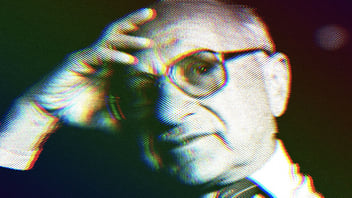 Milton Friedman wearing his signature glasses with his hand resting on his forehead.