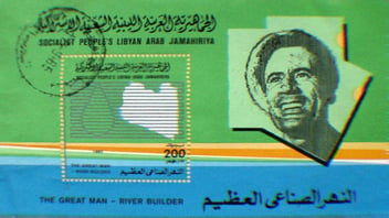 Stamp commemorating Gaddafi as River Builder. His photo accompanies text that reads ‘Socialist People’s Libyan Arab Jamahiriya. The Great Man - River Builder.’