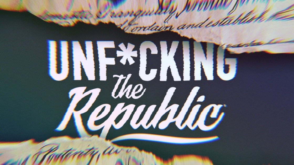 The US Constitution ripped in the middle revealing white text on a blue background that says, ‘Unf*cking the Republic.’ Letters have a glitchy rainbow effect on them.